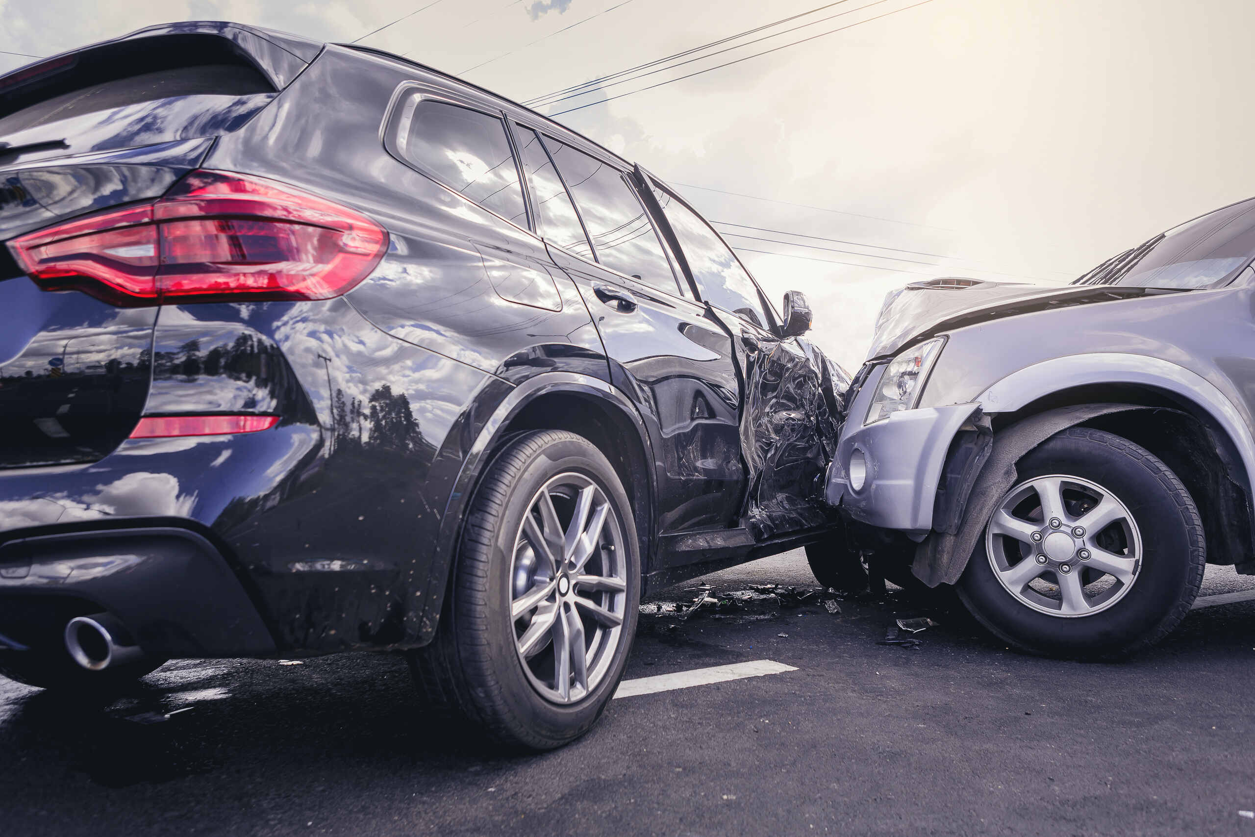 A close-up of a T-bone collision between a black SUV and a silver car, showing a vehicle crash scene handled by Springfield Car Accident Lawyers.