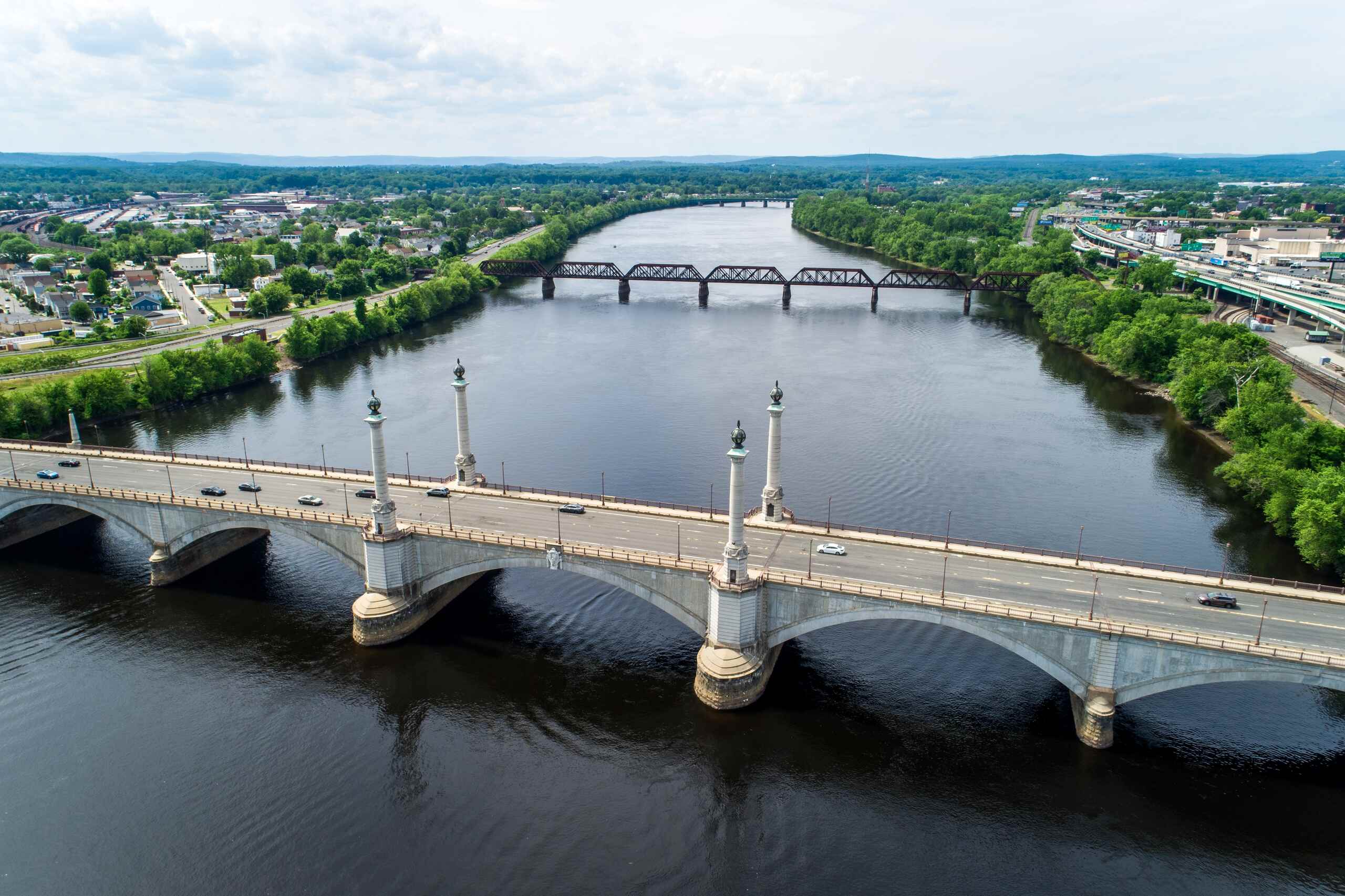 An aerial view of the Memorial Bridge over the Connecticut River, representing the geographic service area for Springfield Car Accident Lawyers.